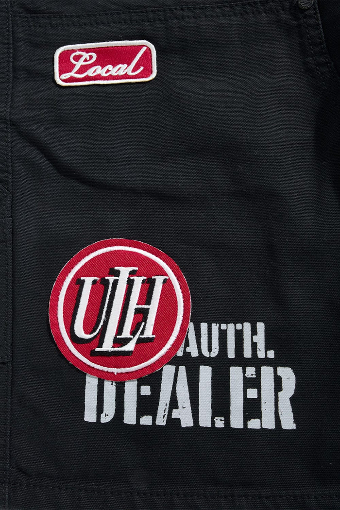 Black Jordan Craig 'Re-Up' shorts with a relaxed fit, featuring the brand's logo on the front, displayed on a plain background.