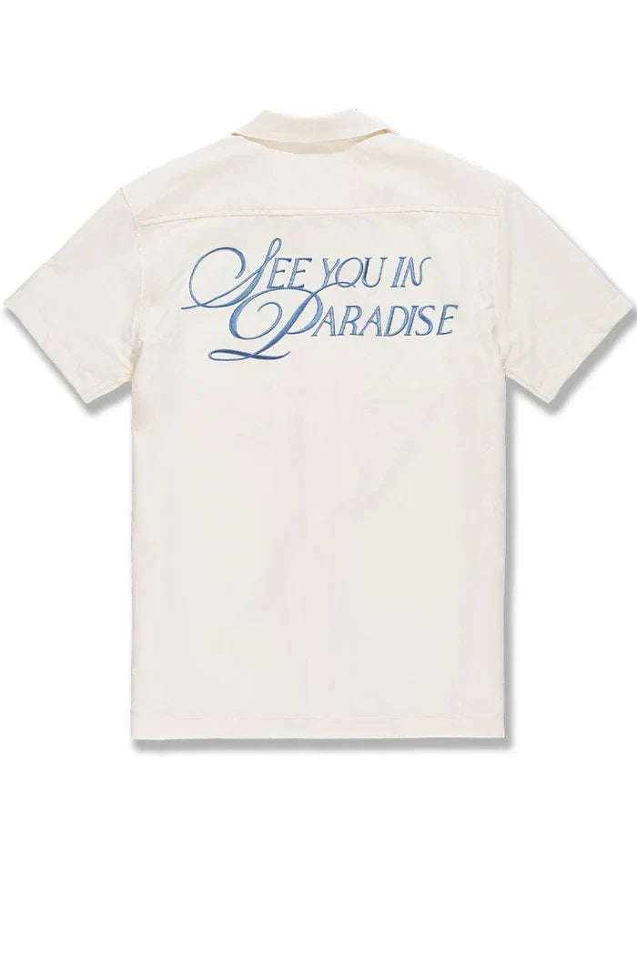 Cream SYIP 'See You in Paradise' short sleeve button-up shirt with a relaxed fit, displayed on a neutral background.