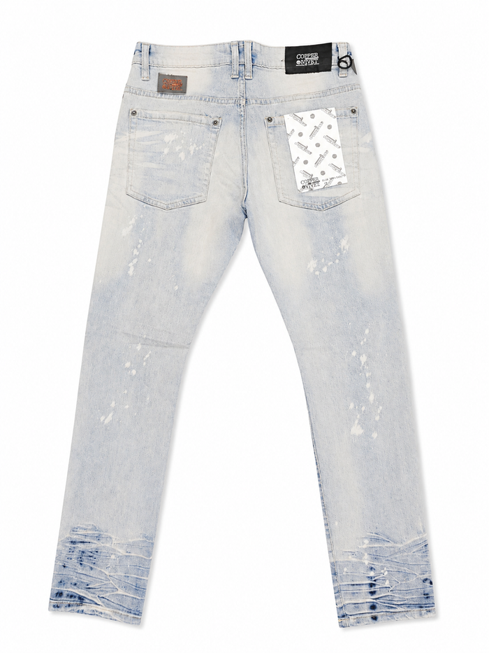 Copper Rivet denim pants with rip and repair details in LSB color, showcasing rugged style and distressed denim fabric.