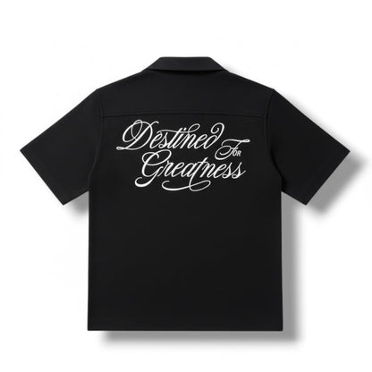 Jordan Craig Kids ‘Greatness Camp’ black short sleeve button-up shirt, stylish kids’ tee with a collared design.