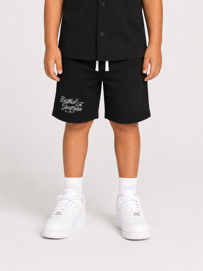 Black Jordan Craig Kids Greatness Camp shorts laid flat, showing athletic design and comfortable fit for children.