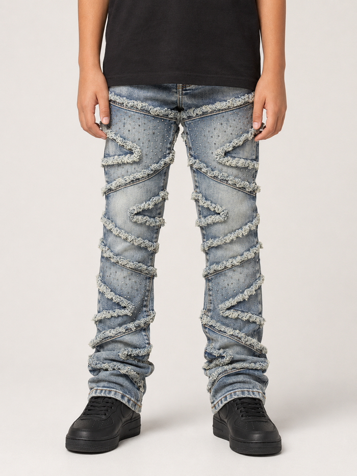 FWRD Kids Stacked Slash denim jeans in light tint, featuring a classic blue denim look with distressed detailing and a relaxed fit.