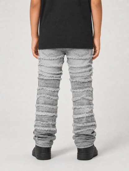 FWRD Kids gray distressed frayed stacked denim jeans with a relaxed fit, showcasing a trendy worn-in look and distressed detailing.