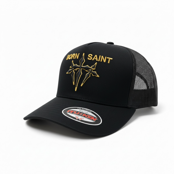 Black MUKA Born Saint trucker hat with mesh back and curved brim, showcasing bold embroidered logo on front.