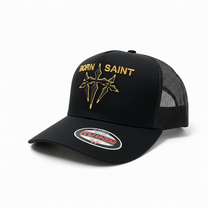 Black MUKA Born Saint trucker hat with mesh back and curved brim, showcasing bold embroidered logo on front.