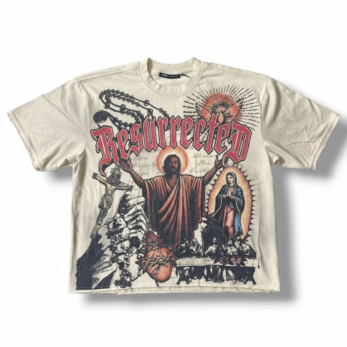 Cream Rebel Minds Jesus Relic cropped T-shirt, featuring religious graphic design and casual fit, displayed on a plain background.