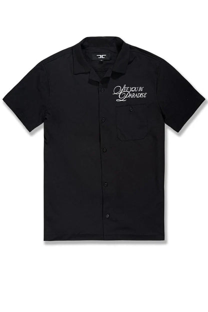 Black SYIP 'See You in Paradise' short sleeve button-up crewneck shirt displayed on a model with a casual fit.