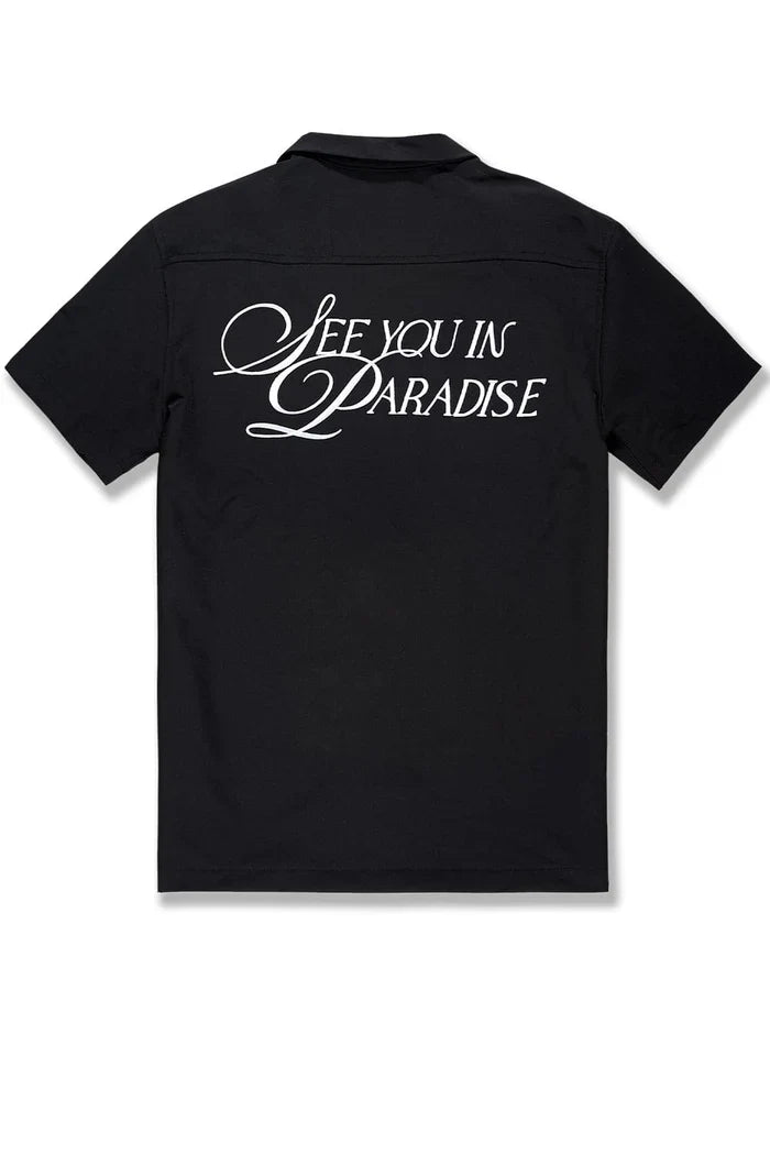 Black SYIP "See You in Paradise" short sleeve button-up shirt displayed on a mannequin, showcasing the relaxed crewneck style.