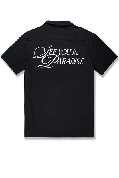 Black SYIP "See You in Paradise" short sleeve button-up shirt displayed on a mannequin, showcasing the relaxed crewneck style.