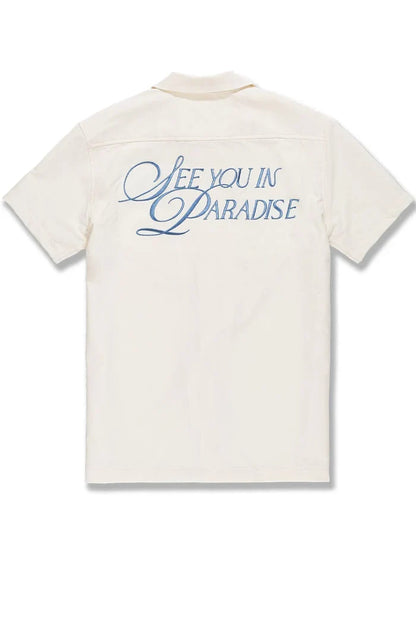 Cream SYIP 'See You in Paradise' short sleeve button-up shirt with a relaxed fit, displayed on a neutral background.