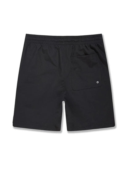 Black SYIP 'See You in Paradise' shorts laid flat, showcasing their relaxed fit and minimalistic design.