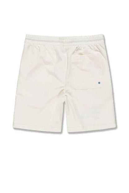SYIP 'See You in Paradise' cream shorts with a relaxed fit, displayed on a hanger against a neutral background.
