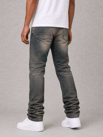 Dark indigo Taker all-over print premium stretch stacked denim jeans showcasing detailed design and fabric texture.