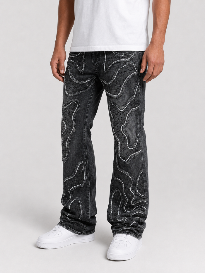 Taker frayed patched premium stretch stack denim in vintage black, featuring distressed details and a slim fit design.