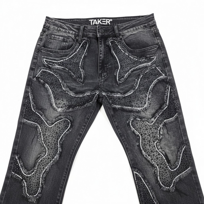 Taker 'Frayed Patched' premium stretch stacked denim jeans in vintage black with distressed and patched details.
