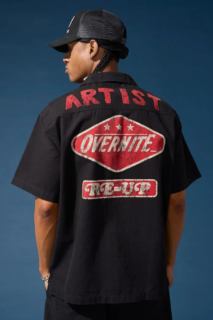 Black Jordan Craig The Re-Up Mechanic's Button-Up Shirt, men's casual tee with collar and button details, model wearing the shirt.